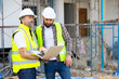 © NVB Stocker - Architect and contractor working on building in construction site. Two Professional Architects Engineer Working on Personal laptop computer at house construction site