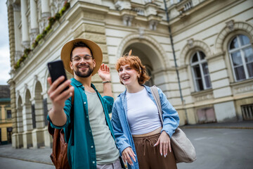 Wall Mural - Young couple, on a vacation, exploring the new city and using their phone as gps to help them not get lost.