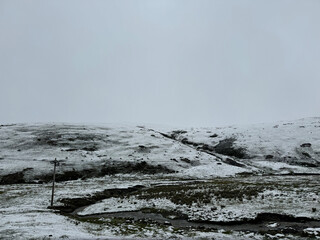 Winter view of highland over 4000m sea level, nature snowy outdoor landscape with a grey sad sky, hill covered in snow with no people