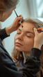 © Aqsapics - young beautiful woman getting makeup at salon