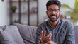 © MinixT - A happy Indian man speaking while glancing at the camera. Generative Ai