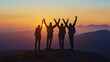 © HC Designer - A group of four hikers standing on the top of the mountain with their arms raised up in the air during the twilight sunset