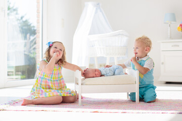 Wall Mural - Kids play with newborn baby brother