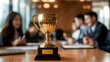 © imran - The esteemed golden trophy is positioned in front of the sales team.