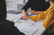 © ARMMY PICCA - Financial analysts analyze business financial reports on a digital tablet planning investment project during a discussion at a meeting of corporate showing the results of their successful teamwork.