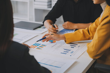 Financial analysts analyze business financial reports on a digital tablet planning investment project during a discussion at a meeting of corporate showing the results of their successful teamwork.