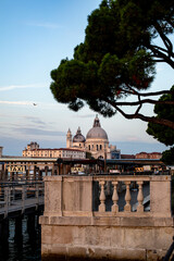 Wall Mural - Sunset view of iconic Venetian architecture and bustling taxi dock along the waterway in Venice, Italy, during a serene evening