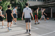 © qunica.com - Friends gather on an old neighborhood court to play basketball, embodying teamwork and enjoyment in a casual outdoor environment.