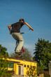 © Edijs - Young boy with scooter is going airborne. Teenagers ride and jump on the ramp in skate park.