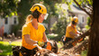 © AI_Kate - The image shows a female arborist wearing a yellow helmet and yellow shirt, working with a chainsaw. She is performing tree cutting tasks, using protective gear including a helmet and goggles