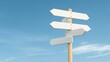 © Nima - A white wooden signpost with multiple blank arrows pointing in different directions against a clear blue sky. This image symbolizes choice, opportunity, direction, and the potential for new beginnings