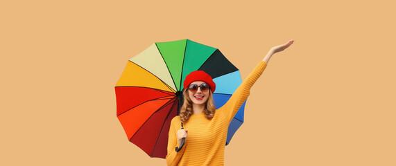 Wall Mural - Autumn color, beautiful happy cheerful young woman holding colorful umbrella, stylish joyful girl