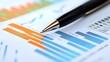 © Handz - Pen Pointing at Bar Graph on Business Report