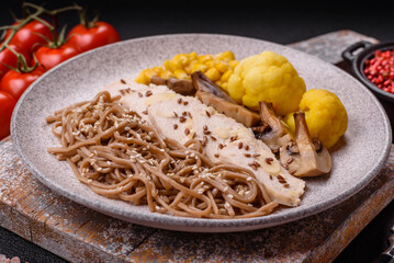 Asian dish with sliced chicken fillet, buckwheat noodles, soy sauce