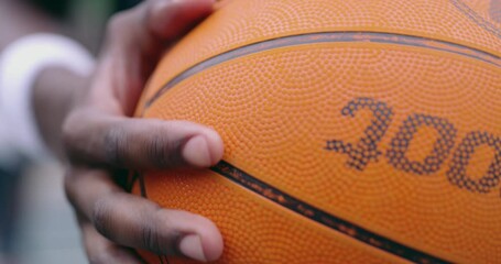 Wall Mural - Black man hand touching the basketball texture before fitness, exercise and training sport workout. Marco zoom on athlete hands holding a orange sports game ball with care after a competition or game