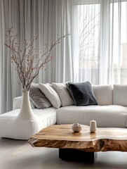 modern minimalist living room interior, white sectional sofa with grey accent pillows, wooden live-edge coffee table, sheer window curtains, decorative dried branches in vase, bright natural lighting,