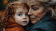 ©  Himadness - A tender moment between an elderly woman and her young granddaughter as they embrace closely, capturing their deep bond and emotional connection.
