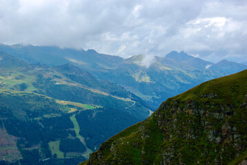 Wall Mural - view of an amazing mountain landscape on a hazy day with gray clouds and fog over the peaks in autum