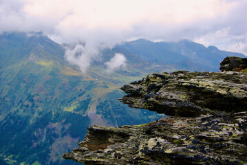 Wall Mural - view of an amazing mountain landscape on a hazy day with gray clouds and fog over the peaks in autum