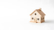 © Tark - Toy wooden house on white background symbolizing home ownership space for text. Generative AI