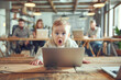 © Pavel Iarunichev - In a bright coworking space, a baby leans over a laptop with wide eyes, expressing astonishment.