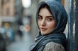 © Dalibor - Young woman in a hijab, leaning against a wall, gazing softly with a serene expression.