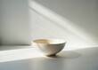 © kittipon - minimalist simplicity quiet morning solitude delicate porcelain bowl glowing soft white light fragile emptiness serene calmness stillness creamy whites subtle shadows