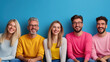 © khonkangrua - A group of five diverse friends smiling and sitting against a blue background, representing friendship, diversity, and happiness.