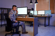© Pixel-Shot - Young male soldier with headset using computer in headquarters at night