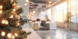 © InfiniteStudio - Christmas tree in modern office with decorations and lights blurred festive workspace concept