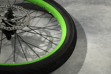 Canvas Print - Bicycle wheel with tire on grey background, closeup