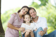 © DG PhotoStock - Happy family relaxing together at the park, caucasian family with father, mother, and children walking at the park.