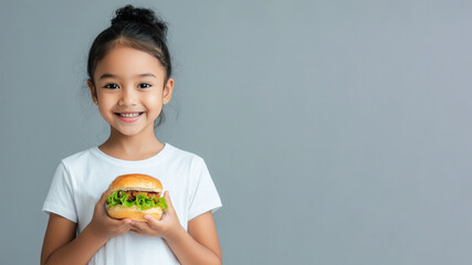 Malay little girl smile holding hamburger fast food for student lunch