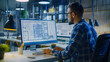 © Gita - A male architect wearing glasses closely analyzes detailed blueprints on a large monitor in a modern, well-lit office environment, focusing on precision and design.