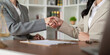© Natee Meepian - Professional handshake sealing real estate contract agreement