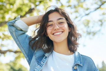 Wall Mural - Canadian woman in casual shirt smile arm on head at sunny park