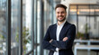© muhammadarslan - professional man, portrait of a smiling businessman, attractive smiling businessman in his late thirties standing with arms crossed looking at the camera, wearing a business suit and white shirt