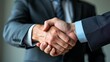 © Din Nasahrudin - Professional handshake sealing a deal with blurred background highlighting business partnership.
