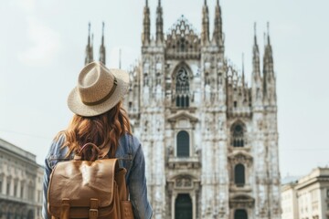 A traveler admires the stunning architecture of a historic cathedral. The stylish woman with a backpack enjoys her journey. Embrace the beauty of exploration. Generative AI