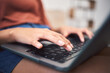 © Azee Jacobs/peopleimages.com - Woman, hands and home laptop for research, working employee and copywriting editor on couch. Female person, email client and reading review of project in living room, freelancer and networking site