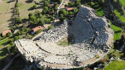 Wall Mural - View from drone of ruins of Roman amphitheater at archaeological site of ancient city of Selge and picturesque surroundings on spring day, Altinkaya, Turkey