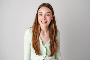 Smiling Young Woman Against White Background in Studio