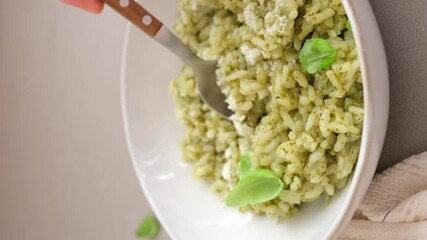 Canvas Print - Green pesto risotto with parmesan, white marble background.