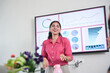 © GAJENDRRA BHATI  - Cheerful Young indian woman at office explaining about business project in presentation or meeting. Start up, leadership and workplace concept.