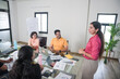 © GAJENDRRA BHATI  - Young indian woman at office discussing about business growth to team members or colleagues in meeting. Start up, leadership, presentation and workplace communication concept.