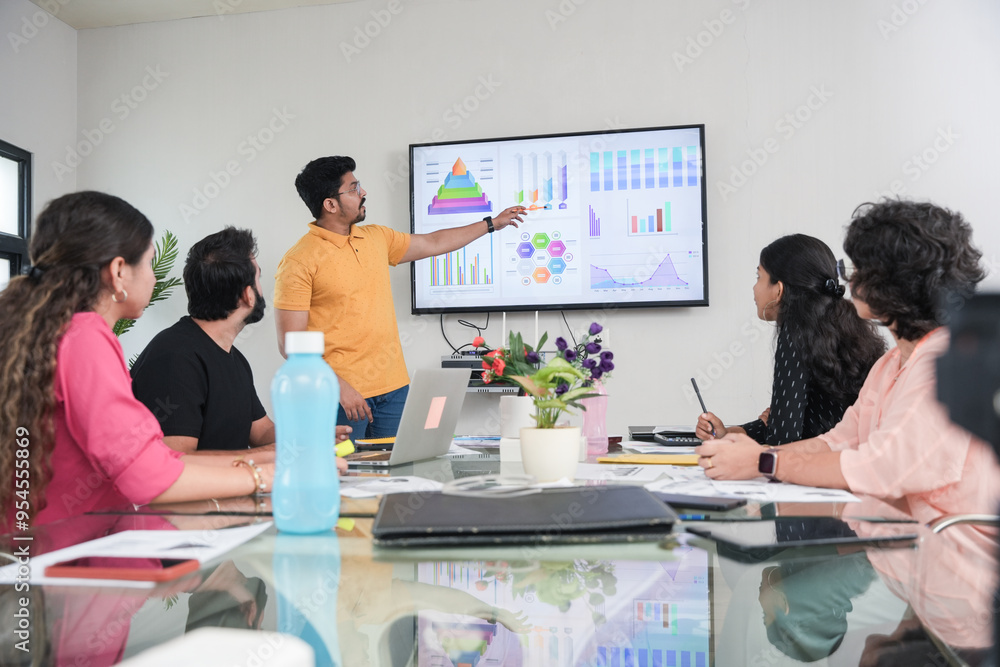 young indian man presents business financial data with charts and ...
