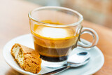 Macchiato coffee in the glass cup and piece of cake