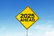 © Creativa Images - Close up of yellow signpost with text of 2025 ahead with blue sky background