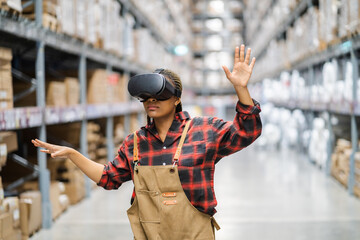 Wall Mural - Young africn woman wearing virtual reality (VR) goggles stands in middle of warehouse with shelves stocked, traditional workwear and modern technology, technology logistics in industrial and warehouse