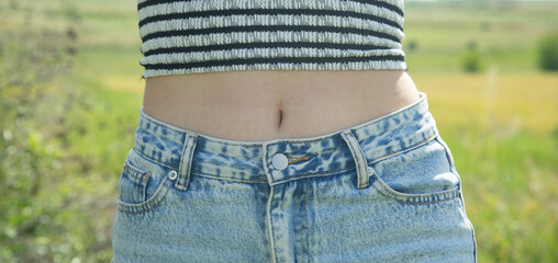 Wall Mural - Young girl in blue jeans. Lifestyle